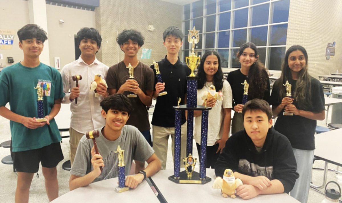 Posing with bright smiles, speech and debate competitors stand proudly as they display their array of trophies won at the Hendrickson Debate Tournament. The tournament not only gave seasoned, returning debaters another chance to showcase their talent, but was also the first opportunity offered to sophomore novices to try out a varsity level competition. 